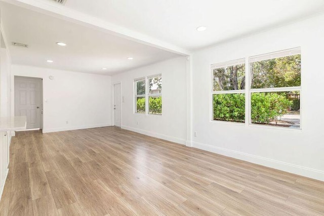 unfurnished room with light wood-type flooring