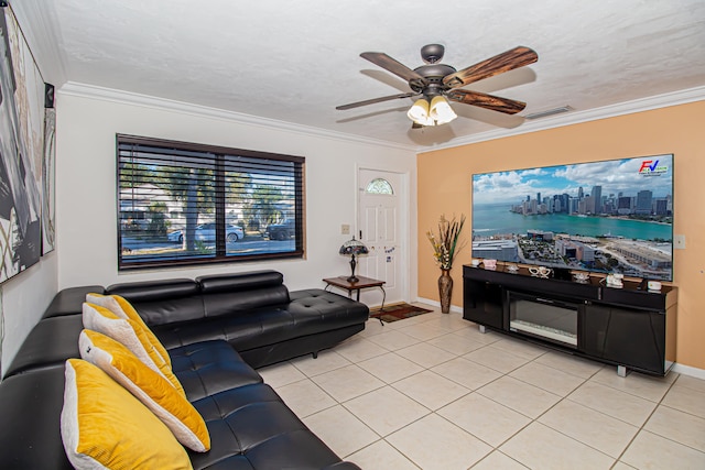 tiled living room with ceiling fan, ornamental molding, and a textured ceiling