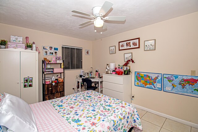 bedroom with light tile patterned floors, a textured ceiling, and ceiling fan