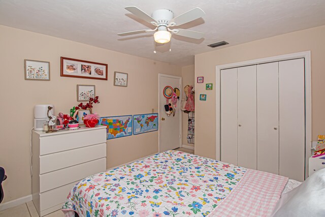 bedroom with ceiling fan and a closet