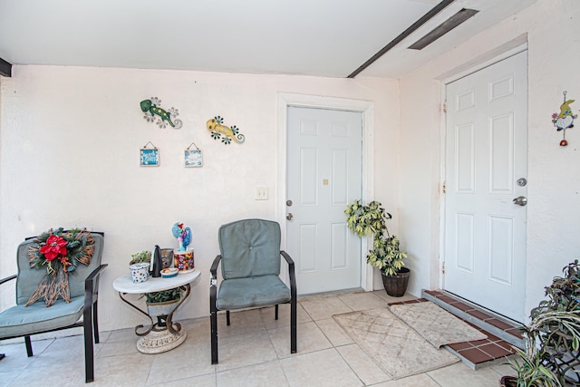 sitting room featuring light tile patterned flooring