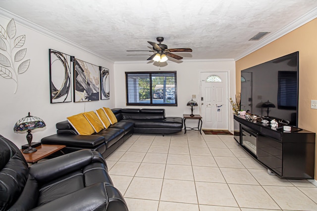 living room featuring a textured ceiling, light tile patterned floors, and crown molding