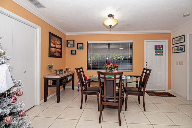 dining space with light tile patterned floors and ornamental molding