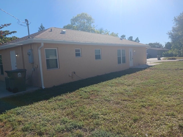 view of side of home featuring a lawn