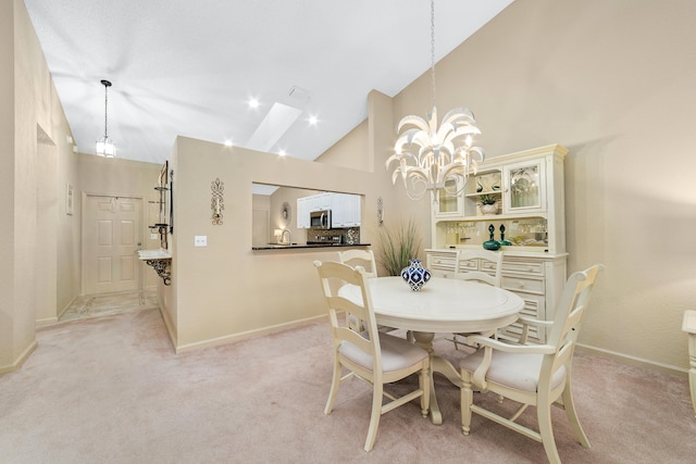 carpeted dining space with sink, high vaulted ceiling, and a notable chandelier