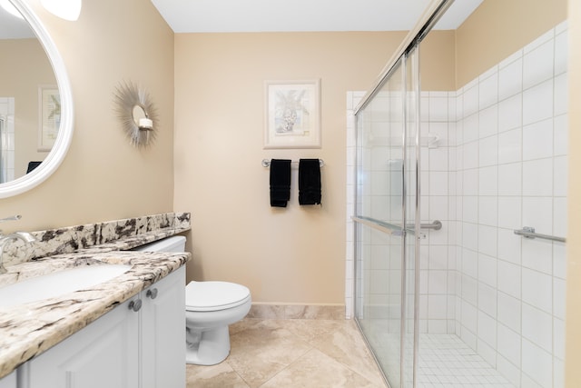 bathroom with tile patterned flooring, vanity, toilet, and walk in shower