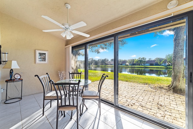 sunroom / solarium with a water view, ceiling fan, and lofted ceiling