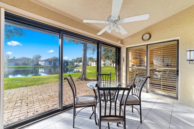 sunroom / solarium featuring a water view, ceiling fan, and lofted ceiling