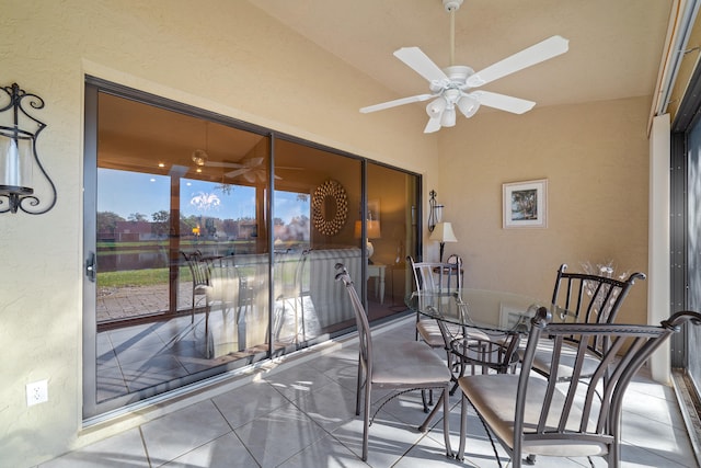 sunroom / solarium featuring ceiling fan