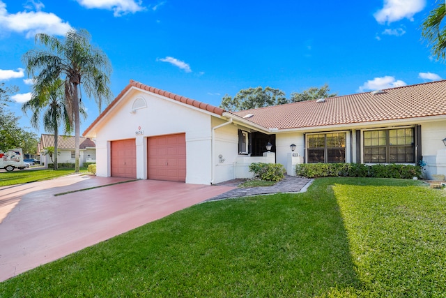 view of front of house with a garage and a front lawn