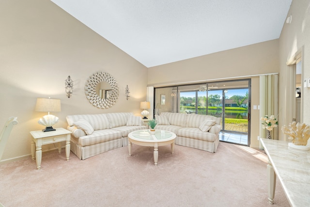 living room with carpet floors and high vaulted ceiling