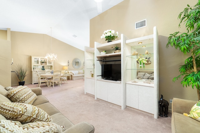 carpeted living room featuring an inviting chandelier and vaulted ceiling