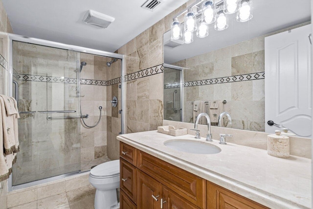 bathroom with vanity, toilet, an enclosed shower, and tile walls