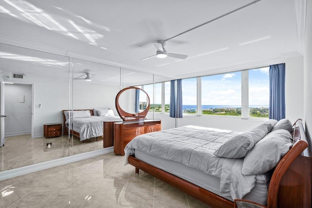 bedroom with ceiling fan and crown molding