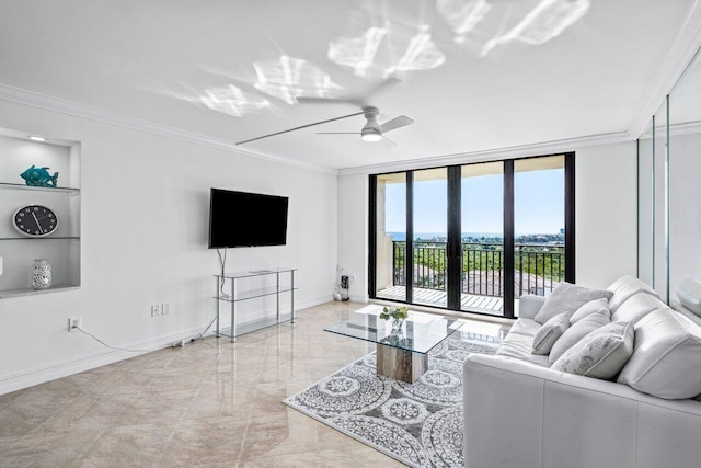 living room featuring built in shelves, ceiling fan, expansive windows, and ornamental molding