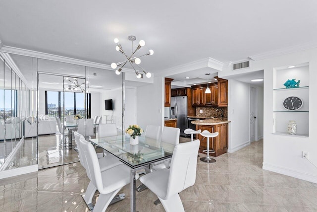 dining room featuring crown molding and a chandelier