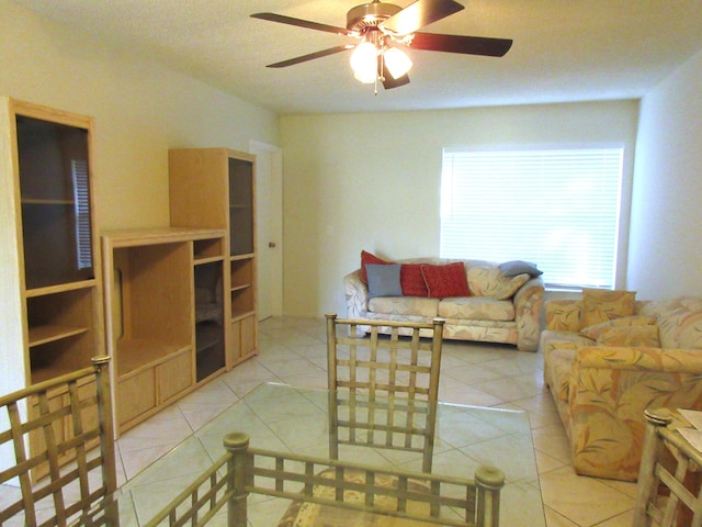 tiled living room with ceiling fan