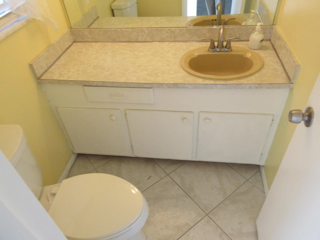 bathroom featuring toilet, vanity, and tile patterned floors