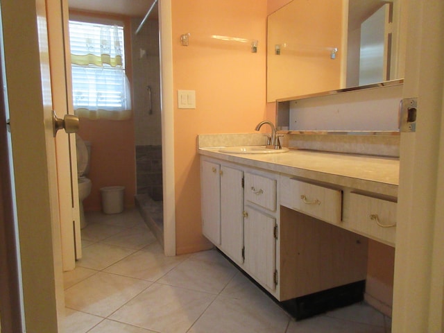 bathroom featuring vanity, tile patterned floors, and toilet