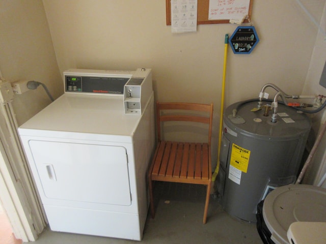 clothes washing area with washer / clothes dryer and water heater