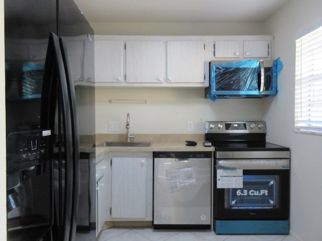 kitchen featuring dishwasher, a healthy amount of sunlight, black refrigerator with ice dispenser, electric range, and sink