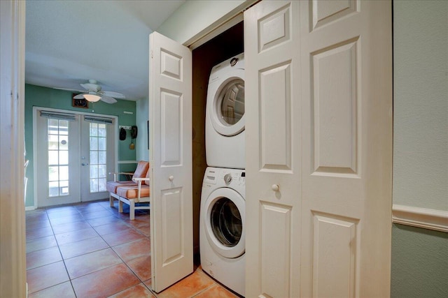 clothes washing area featuring ceiling fan, light tile patterned floors, stacked washer and dryer, and french doors