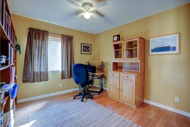 office area featuring light hardwood / wood-style flooring and ceiling fan