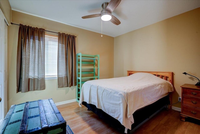 bedroom with ceiling fan and wood-type flooring