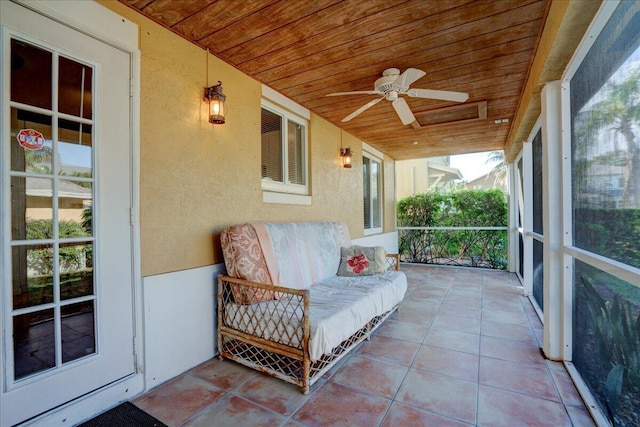 sunroom / solarium with ceiling fan and wooden ceiling