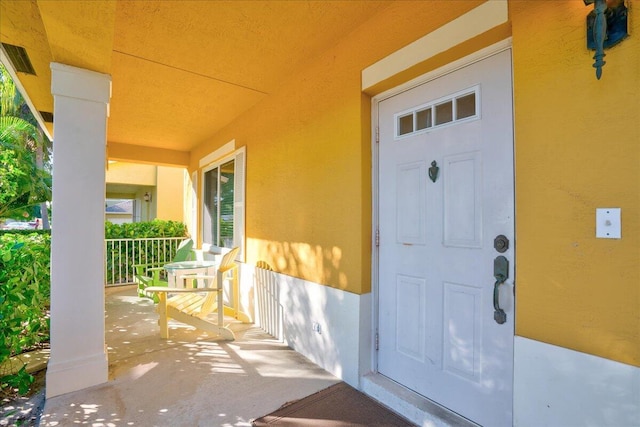 property entrance featuring covered porch