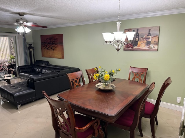 tiled dining room featuring ceiling fan with notable chandelier, a textured ceiling, and ornamental molding