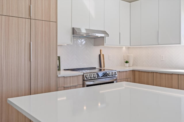 kitchen with decorative backsplash, light brown cabinets, range hood, white cabinetry, and stainless steel electric range