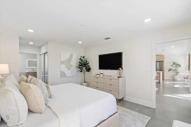 bedroom with recessed lighting, freestanding refrigerator, visible vents, and baseboards