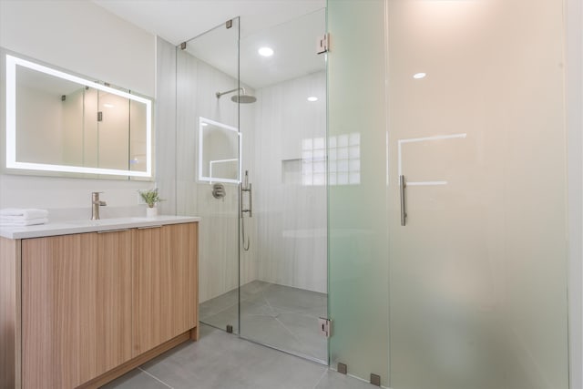 full bathroom with a stall shower, tile patterned flooring, and vanity