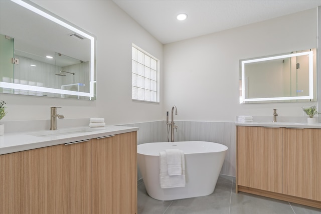 bathroom with visible vents, wainscoting, a soaking tub, vanity, and a shower stall