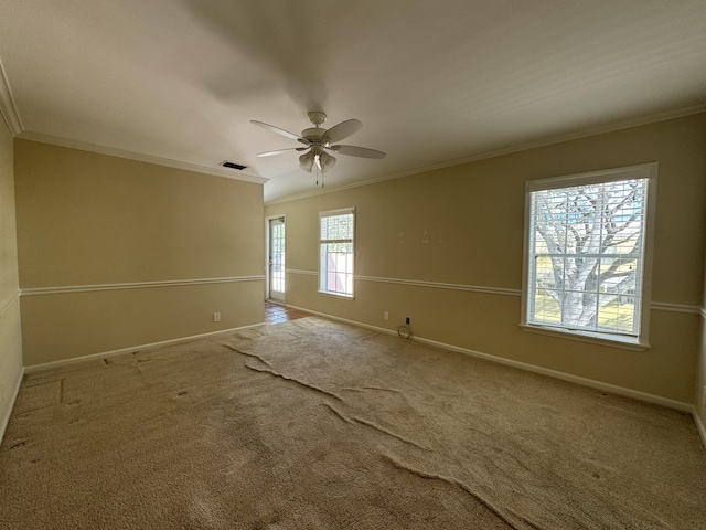 carpeted spare room featuring ceiling fan and crown molding