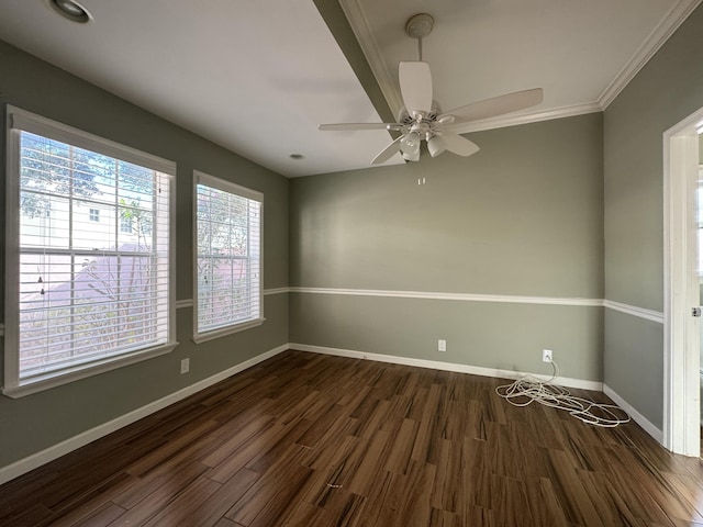 spare room with crown molding, ceiling fan, and dark wood-type flooring