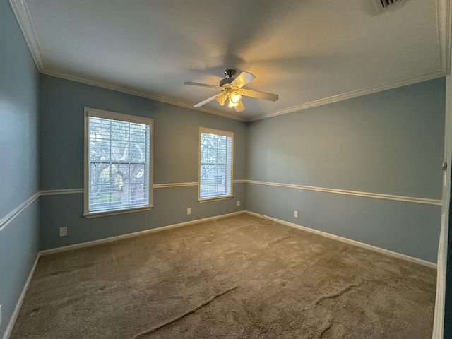 carpeted empty room featuring ceiling fan and crown molding