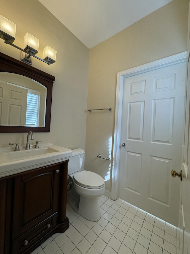 bathroom featuring tile patterned flooring, vanity, and toilet