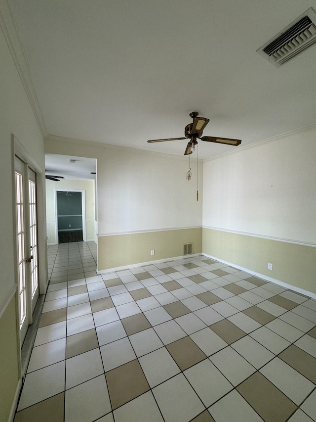 tiled empty room featuring crown molding and ceiling fan