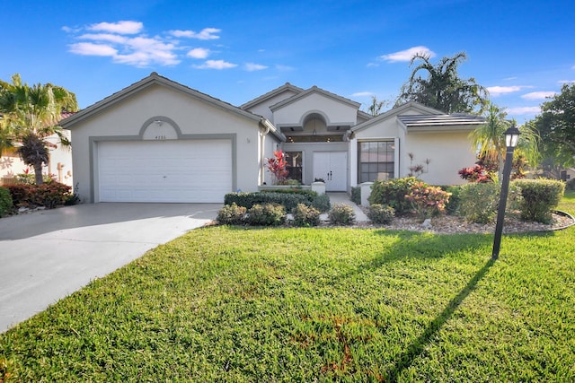 single story home featuring a garage and a front yard