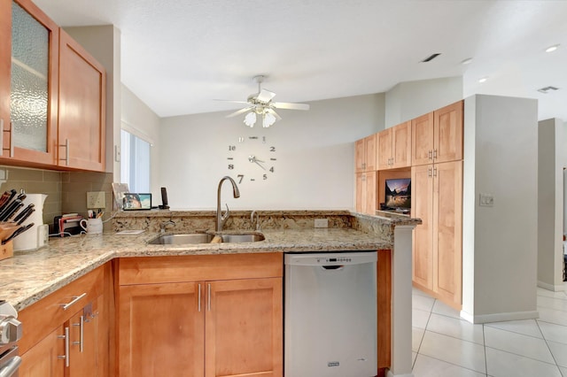 kitchen featuring kitchen peninsula, light stone counters, dishwasher, and sink