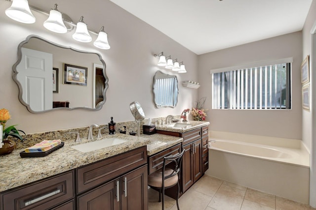 bathroom with tile patterned flooring, a bath, and vanity