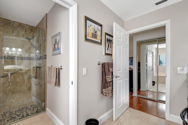 bathroom featuring hardwood / wood-style flooring and a shower with shower door