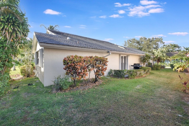 view of side of home featuring a yard