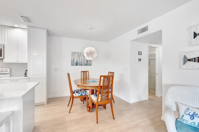 dining room with light hardwood / wood-style floors