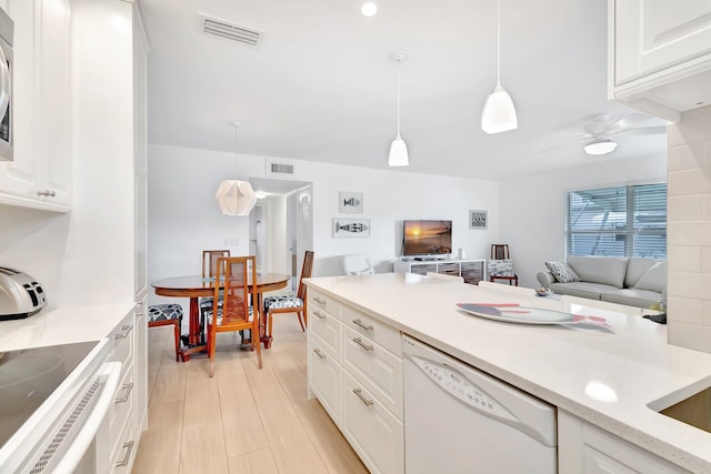 kitchen with ceiling fan, dishwasher, hanging light fixtures, white cabinets, and range