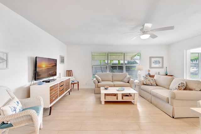 living room with ceiling fan and light hardwood / wood-style floors