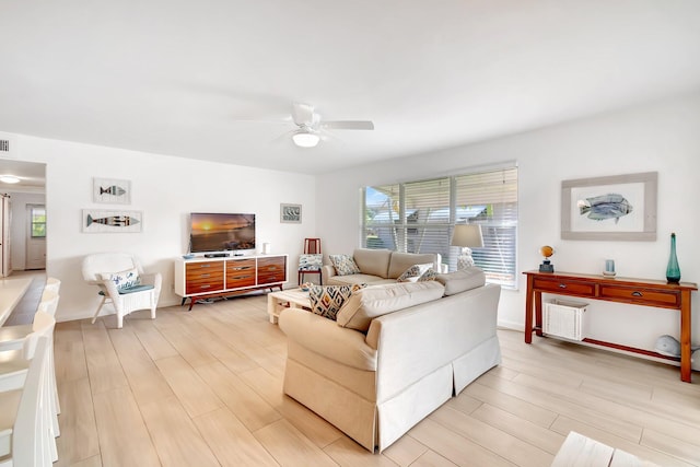 living room with ceiling fan and light hardwood / wood-style floors