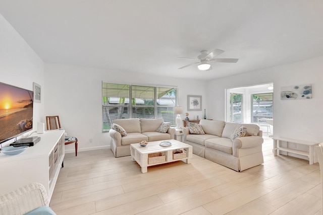 living room featuring ceiling fan and light wood-type flooring